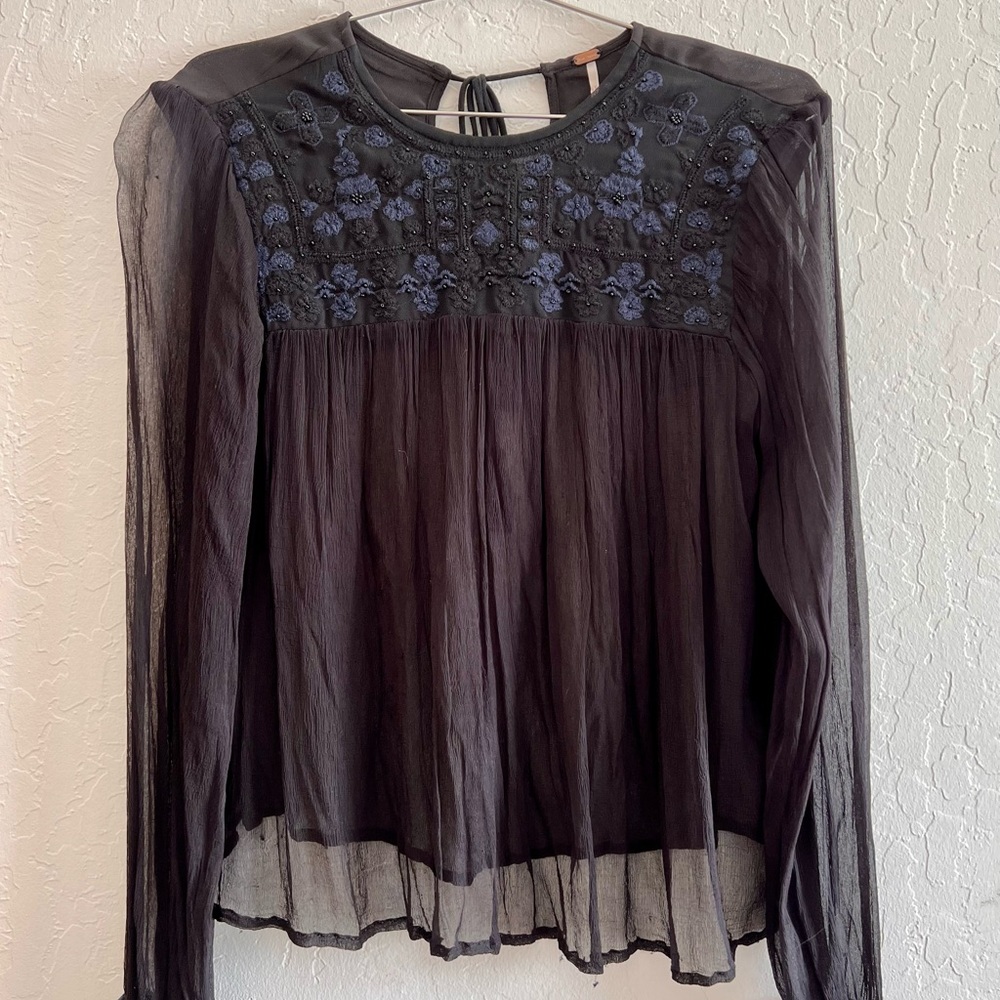 blouse with beautiful embroidery & beading pairs -nicely with a black tank top.